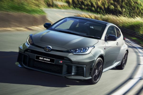 Gray Toyota GR Yaris (in motion on a curvy road): Features "GR YARIS" badging and sporty design, capturing its dynamic performance aesthetic in a scenic setting.