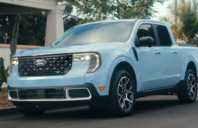 2026 Ford Maverick pickup in Robins Egg Blue parked on the street in front of a home