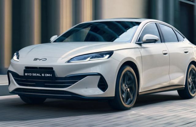 BYD Seal 0M: Sleek, creamy EV glides urban streets—sharp style, smooth electric drive. Modern motion, redefined.