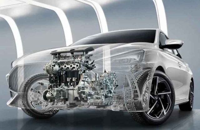 A silver sedan with a transparent design revealing its engine and mechanical components, displayed in a futuristic, well-lit space, emphasizing automotive engineering and technical innovation.