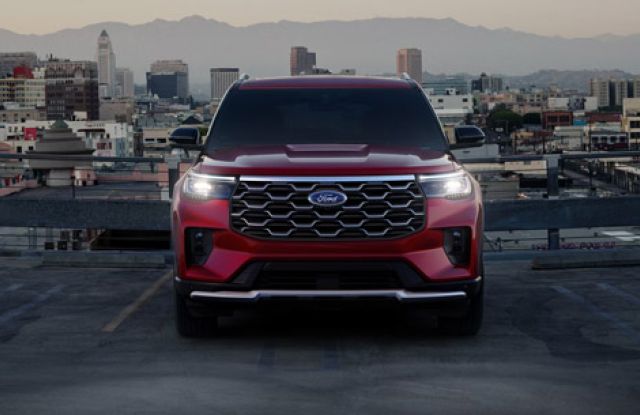 The front of a 2026 Ford Explorer SUV with the headlamps illuminated