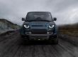 wp-content/uploads/2026/01/Front-view-of-a-blue-Land-Rover-Defender-on-a-rugged-mountain-road-under-cloudy-skies.jpg