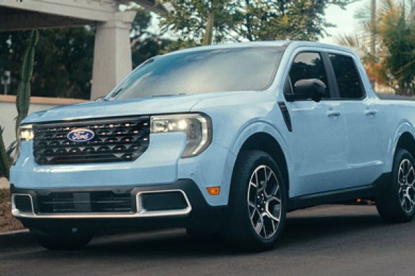 2026 Ford Maverick pickup in Robins Egg Blue parked on the street in front of a home