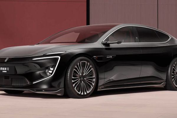 2025 Avatr 12 with sleek design, alloy wheels, displayed in modern indoor setting.