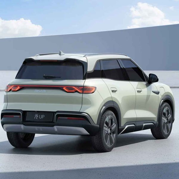 Rear - three - quarter view of a light green BYD Yuan UP SUV, showcasing its sleek design and modern taillights.