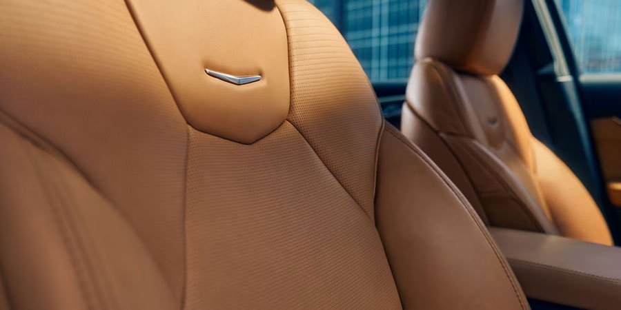Sun Shining on the 2025 Cadillac CT5 Crest on Front Leather Seats