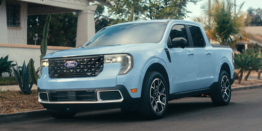 2026 Ford Maverick pickup in Robins Egg Blue parked on the street in front of a home