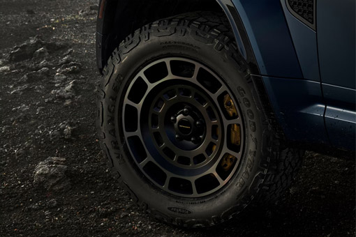Close-up of an Land Rover Defender wheel on rough terrain