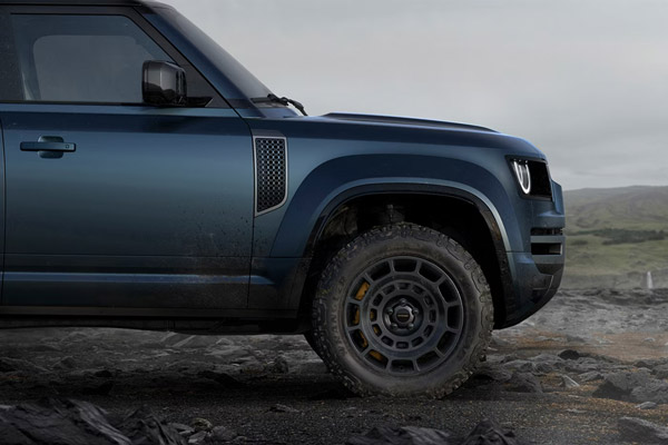 Side view of Land Rover Defender on Rocky hill road
