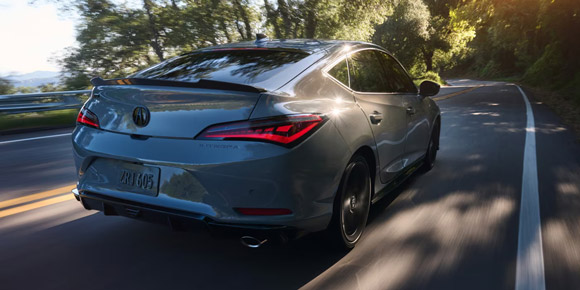 2026 Acura Integra car in Urban Gray Pearl driving on the road.