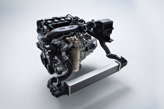 A modern car engine assembly, featuring an intercooler and air intake system, is displayed against a clean white studio background to highlight its intricate mechanical design.