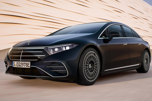 Black Mercedes-Benz EQS on light roadway against wave-shaped backdrop