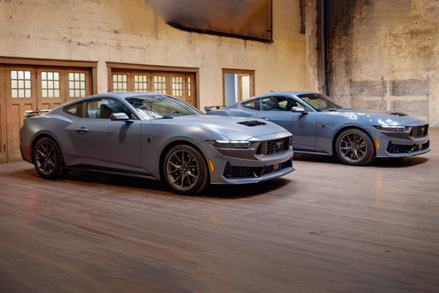 Two 2026 Ford Mustang® Fastbacks parked in a garage, one with the available Matte Clear Film