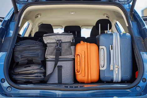 A car with its trunk full of suitcases