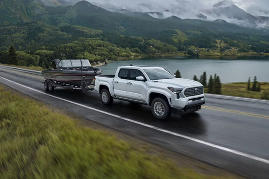 A 2026 Toyota Tacoma towing a speedboat
