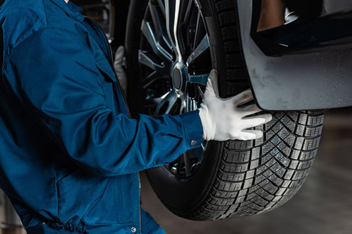 Workers inspect tires
